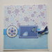 Biglietto Natale azzurro con uccellino e fiocchi di neve