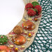 Collana realizzata a mano con base in crochet, frutta e borchie