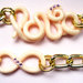 Bracciale catena dorata, simbolo infinito e scritta love, in fimo, con strass