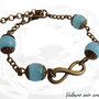 Bracciale simbolo infinito  bronzo perle azzurre vetro vintage
