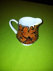 bricco di ceramica rivestito con bucce di arancia