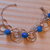 bracciale con pietre blu e campanelline