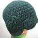 Cappello lana verde uncinetto con decorazioni