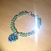 Bracciale in mezzo cristallo verde con perle argentate lisce e ciondolo vetro fiorato a forma di cuore