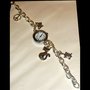 OROLOGIO BRACCIALE CON CHARMS PENZOLANTI A FORMA DI TARTARUGA, PACE, GATTO E  FARFALLA