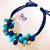 Collana con sfere in vetro blu turchese e oro