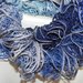 Sciarpa handmade "Filato novità" con bordo argentato "Toni del blu"