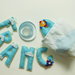 Ghirlanda Francesco in feltro con decorazioni 'aeroplanini tra le nuvole' : un'idea regalo originale per la nascita di un bambino!