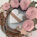 Corona di legno con rose in lino rosa e cuore di legno