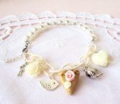 Bracciale con perle bianche, catena color panna, macaron a forma di cuore, torta in fimo e charms
