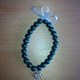 Bracciale di perle con fiocco e charm