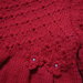 Vestitino di lana rossa con fiorellini e perline realizzato ai ferri