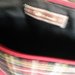 pochette in tessuto (positivo/negativo)scozzese sfondo nero ed eco pelle rossa