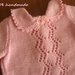 Elegante abito rosa per neonato con cuffietta coordinata realizzato ai ferri in lana merinos