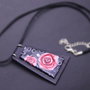 Necklace with red roses fancy  on trapezoidal pendant. 