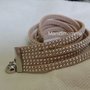 bracciale modello alcantara tonalità beige chiaro con borchie color argento