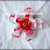 Calamita fiore cinque petali in plastica pet striato rosso