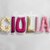 Giulia: una ghirlanda di lettere in cotone e lurex gialle e rosa per decorare la sua cameretta.
