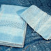 Asciugamani azzurri ricamati punto filza