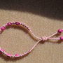 BRACCIALETTO DA BAMBINA FATTO A MANO CON PERLINE FUCSIA, MACRAME'