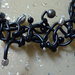 Collana in silicone di colore nero con perle in acciaio, argento, legno e vetro