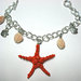 Bracciale grande stella marina rossa con conchiglie pendenti e pesciolini