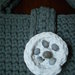 Borsa sottobraccio realizzata all'uncinetto in fettuccia di lycra colore grigio con bottone bianco artigianale con applicazione di conchiglie