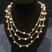 Collana di perle di fiume e cordone color bronzo