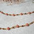 collana lunga con perle in vetro arancioni e swarovski