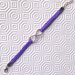 Braccialetto con cordoncino lilla intrecciato a mano e simbolo dell'infinito, con chiusura a moschettone regolabile