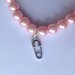 Braccialetto elastico con perle rosa confetto e ciondolini a tema bebè, per future mamme