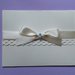 Partecipazione nozze in cartoncino color avorio con nastro di raso