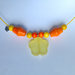 Collana girocollo gialla con perline di legno arancioni e gialle e ciondolo a fiore satinato, fatta a mano
