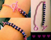 bracciale con perline viola e catenella rosa