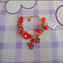 Braccialetto rosso e bianco con charms in metallo smaltati + fimo