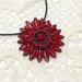 Medaglione Corolla floreale rosso ed ematite
