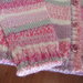 Giacchina  realizzata a mano con pura lana variegata in varie tonalità di rosa, grigio, e bianco