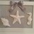 Quadretto shabby con conchiglie in gesso