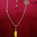 collana lunga in acciaio con nappina gialla in alcantara perle gialle e filigrana color bronzo