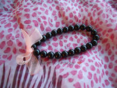 Bracciale con perline nere e fiocco rosa