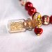 bracciale perle rosso elastico con ciondolo bottiglietta/ampolla in vetro