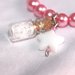 bracciale elastico perle rosa con ciondolo bottiglietta/ampolla e stellina