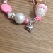 Braccialetto elastico con perle nelle sfumature del rosa e cuoricino 